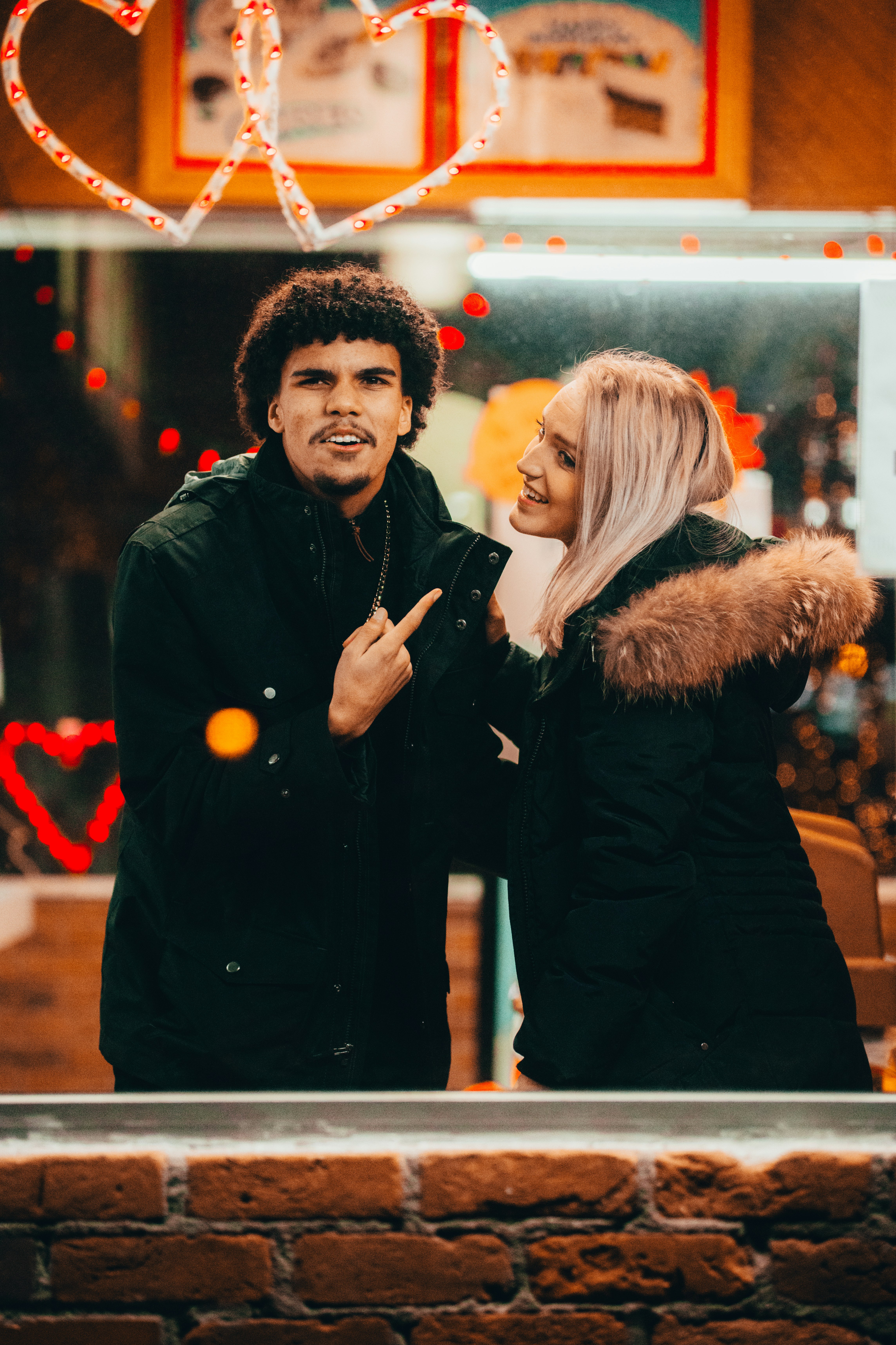 man in black jacket standing beside woman in black coat